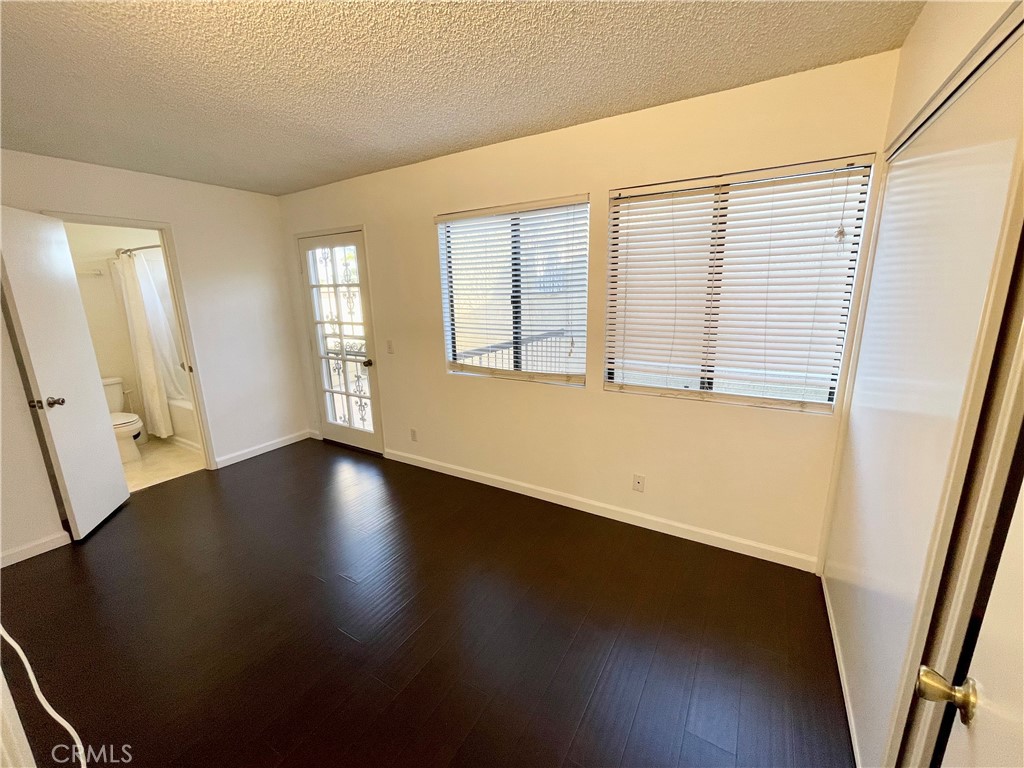 17 Grenache, Unit 72 Irvine, CA 92614 - Photo 15 of 20 a view of an empty room with wooden floor and a window