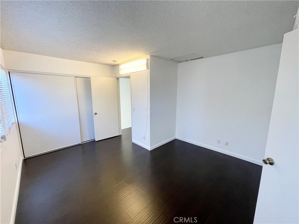 17 Grenache, Unit 72 Irvine, CA 92614 - Photo 16 of 20 a view of an empty room with wooden floor