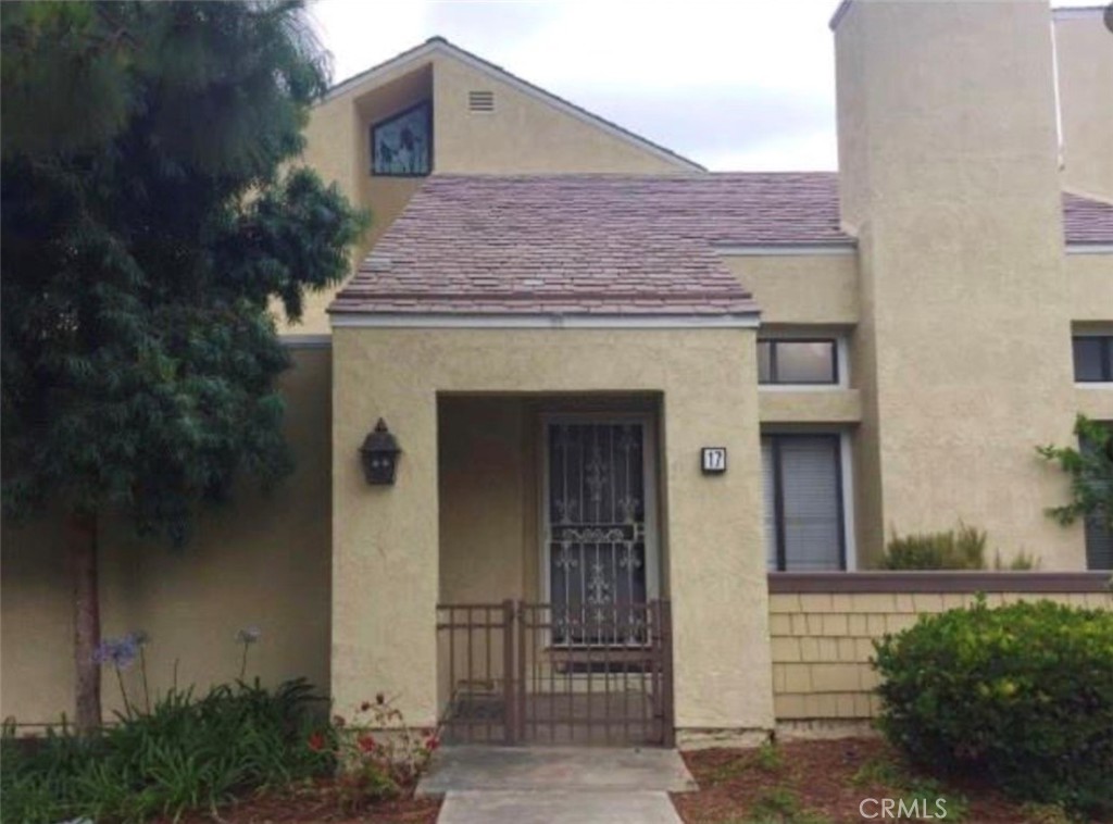 17 Grenache, Unit 72 Irvine, CA 92614 - Photo 2 of 20 a front view of a house with garden