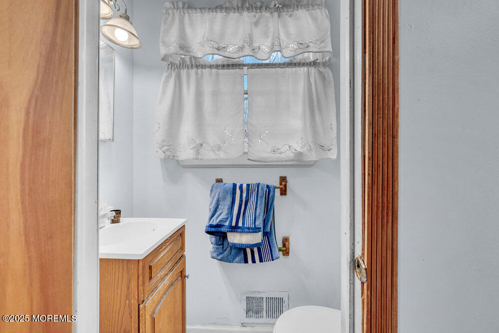 52 Newbury Road Howell, NJ 07731 - Photo 12 of 31 a bathroom with a sink a toilet and a mirror