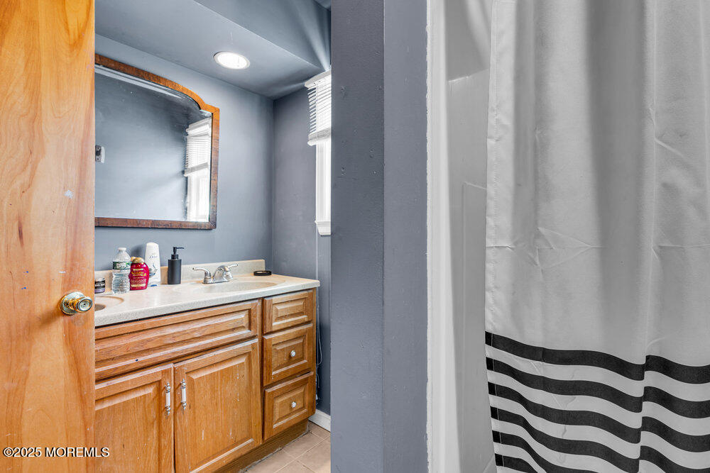 52 Newbury Road Howell, NJ 07731 - Photo 14 of 31 a bathroom with a sink and a mirror