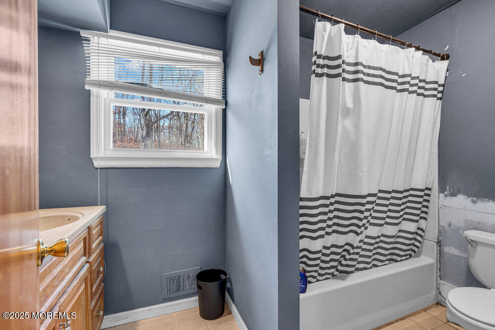 52 Newbury Road Howell, NJ 07731 - Photo 15 of 31 a bathroom with a toilet a sink and a shower