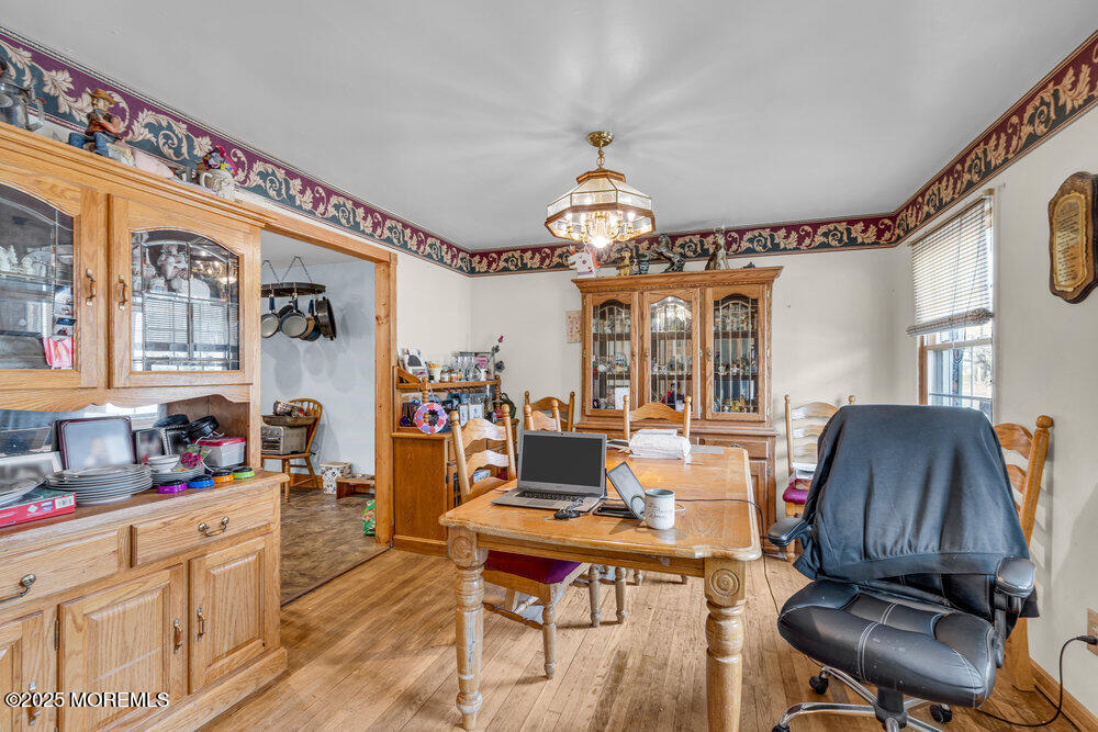 52 Newbury Road Howell, NJ 07731 - Photo 25 of 31 a living room with furniture a chandelier and a flat screen tv
