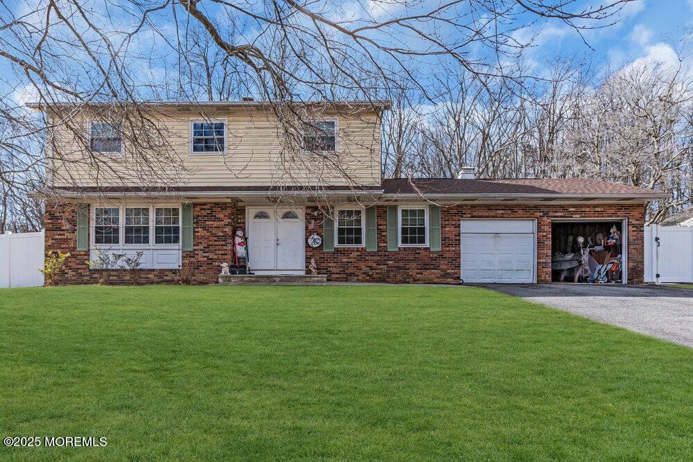 52 Newbury Road Howell, NJ 07731 - Photo 28 of 31 a front view of a house with a garden