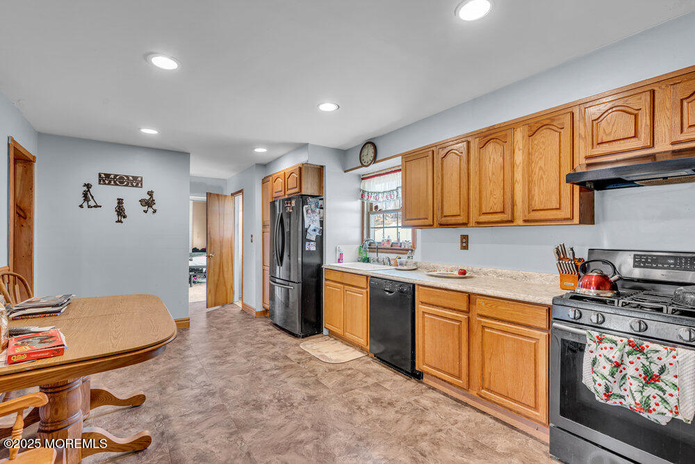 52 Newbury Road Howell, NJ 07731 - Photo 3 of 31 a kitchen with stainless steel appliances granite countertop a sink stove and refrigerator