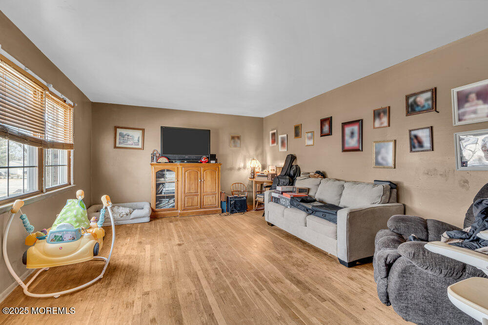 52 Newbury Road Howell, NJ 07731 - Photo 6 of 31 a living room with furniture and a flat screen tv