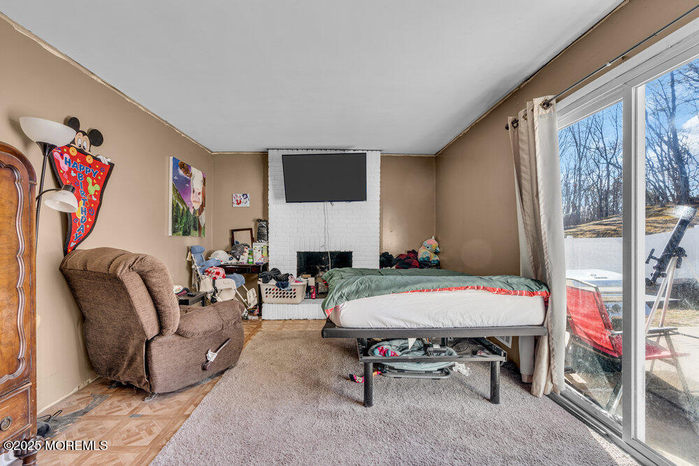 52 Newbury Road Howell, NJ 07731 - Photo 8 of 31 a living room with furniture a flat screen tv and a table