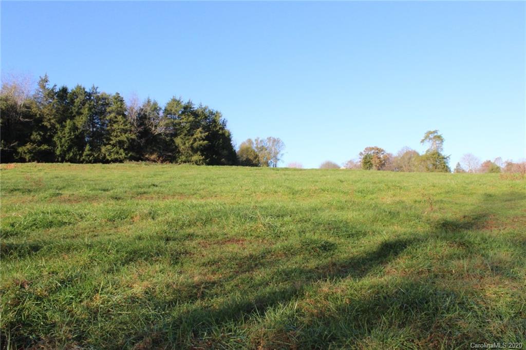 0 Calhoun Road Stony Point, NC 28678 - Photo 37 of 48 a view of a big yard with lots of green space and mountain view in back