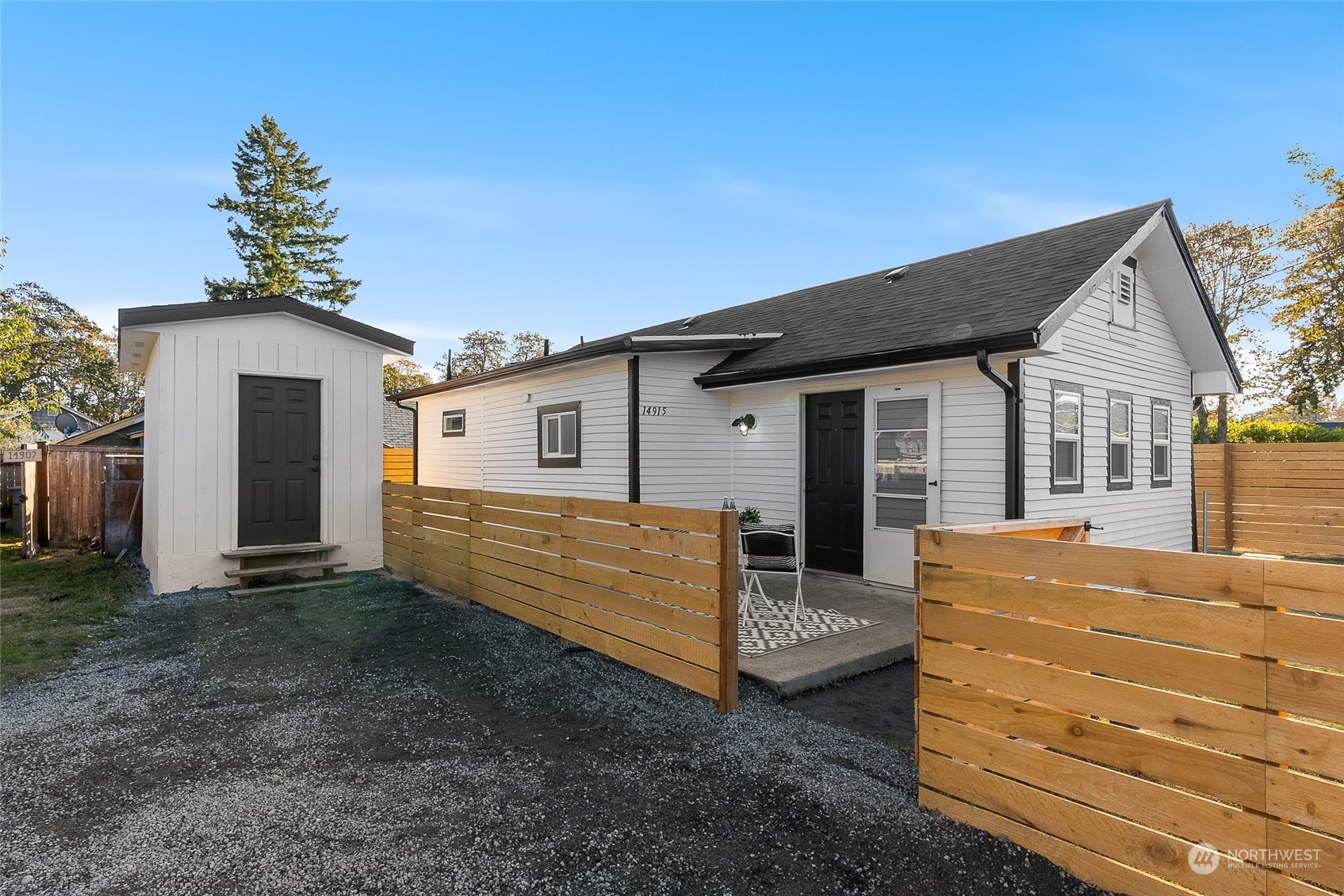 14915 Portland Avenue Southwest Lakewood, WA 98498 - Photo 2 of 24 a view of a house with a yard and wooden fence