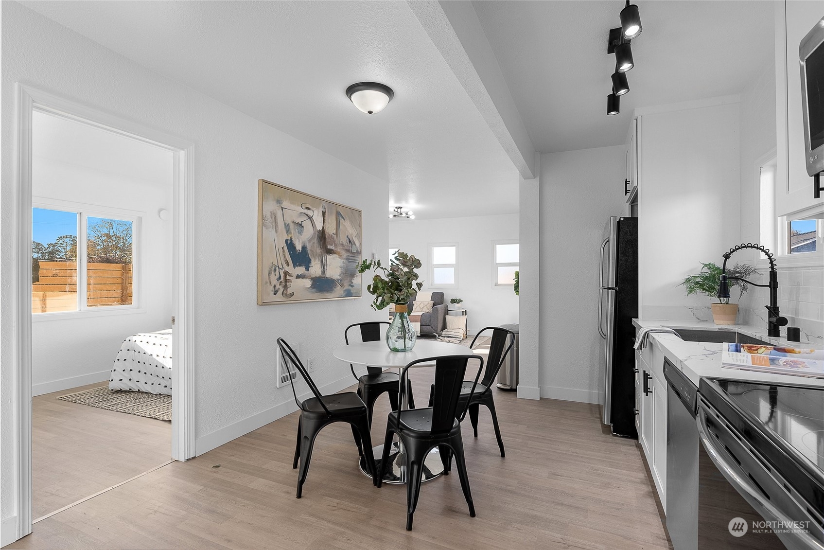 14915 Portland Avenue Southwest Lakewood, WA 98498 - Photo 8 of 24 a view of a dining room with furniture and wooden floor