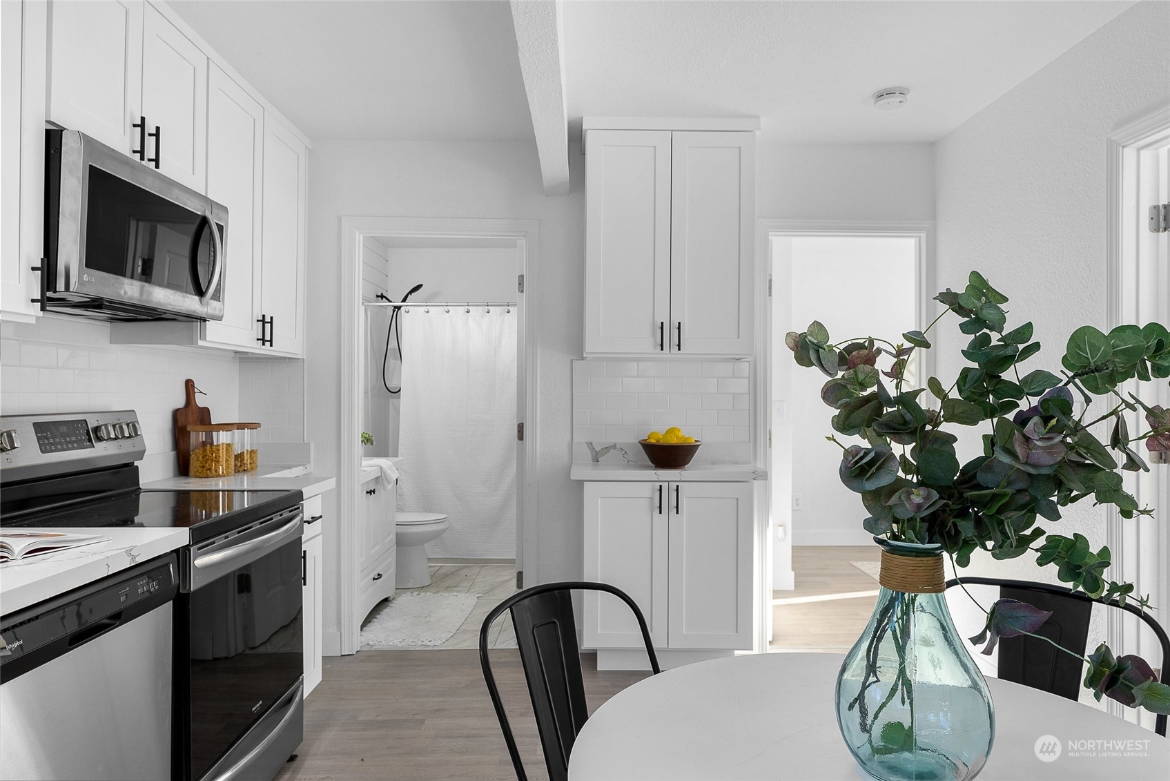 14915 Portland Avenue Southwest Lakewood, WA 98498 - Photo 9 of 24 a kitchen with stainless steel appliances a sink a microwave a refrigerator and cabinets