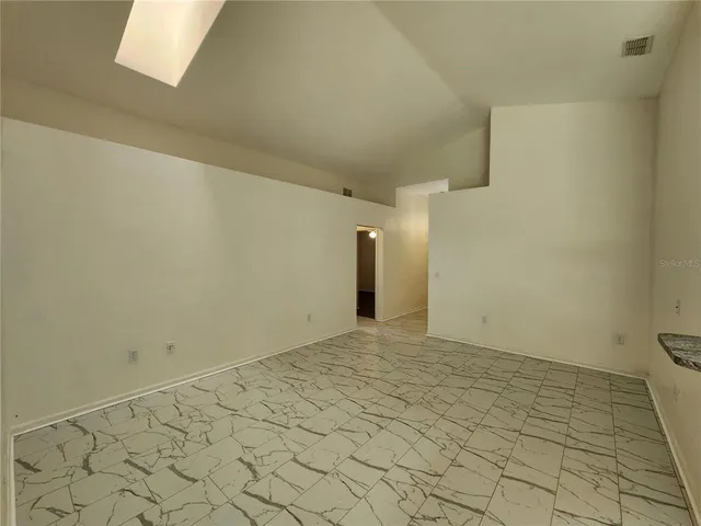 a view of a kitchen cabinets and a refrigerator