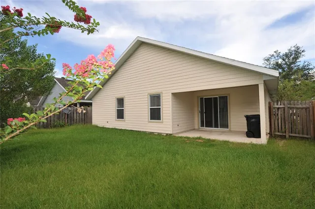 a front view of house with a garden