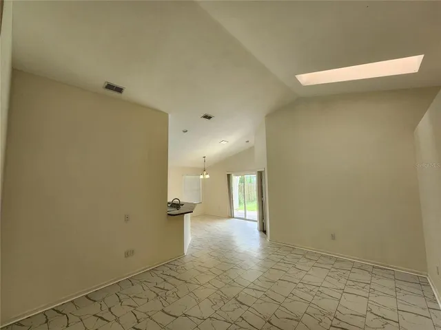 a view of a room with wooden floor and fan