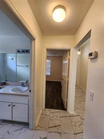 a bathroom with a double vanity sink toilet mirror and bathtub