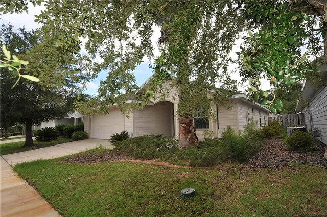 a front view of house with yard and trees