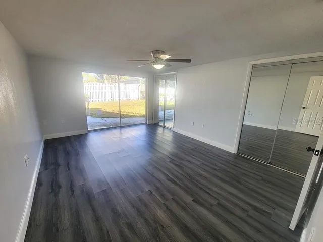 wooden floor in an empty room with a window