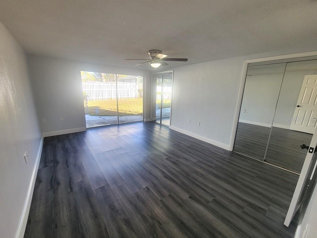 7741 Treasure Pointe Drive Port Richey, FL 34668 - Photo 14 of 20 wooden floor in an empty room with a window