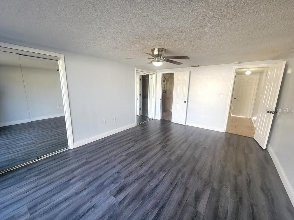 7741 Treasure Pointe Drive Port Richey, FL 34668 - Photo 15 of 20 wooden floor in an empty room with a window