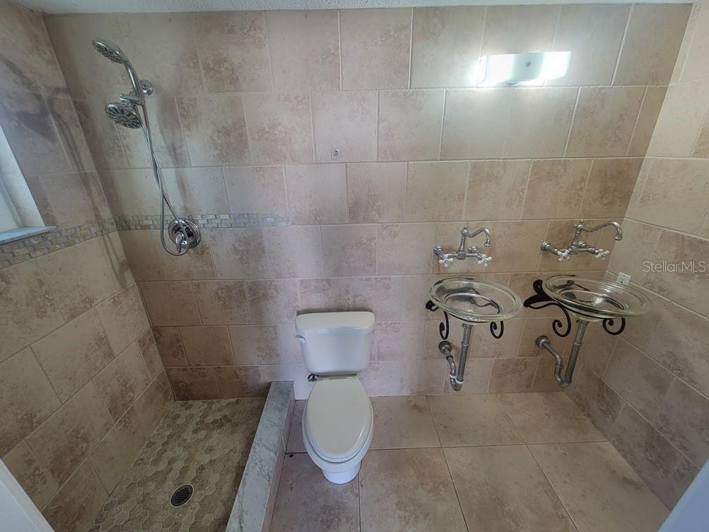 7741 Treasure Pointe Drive Port Richey, FL 34668 - Photo 16 of 20 a bathroom with a toilet and a shower