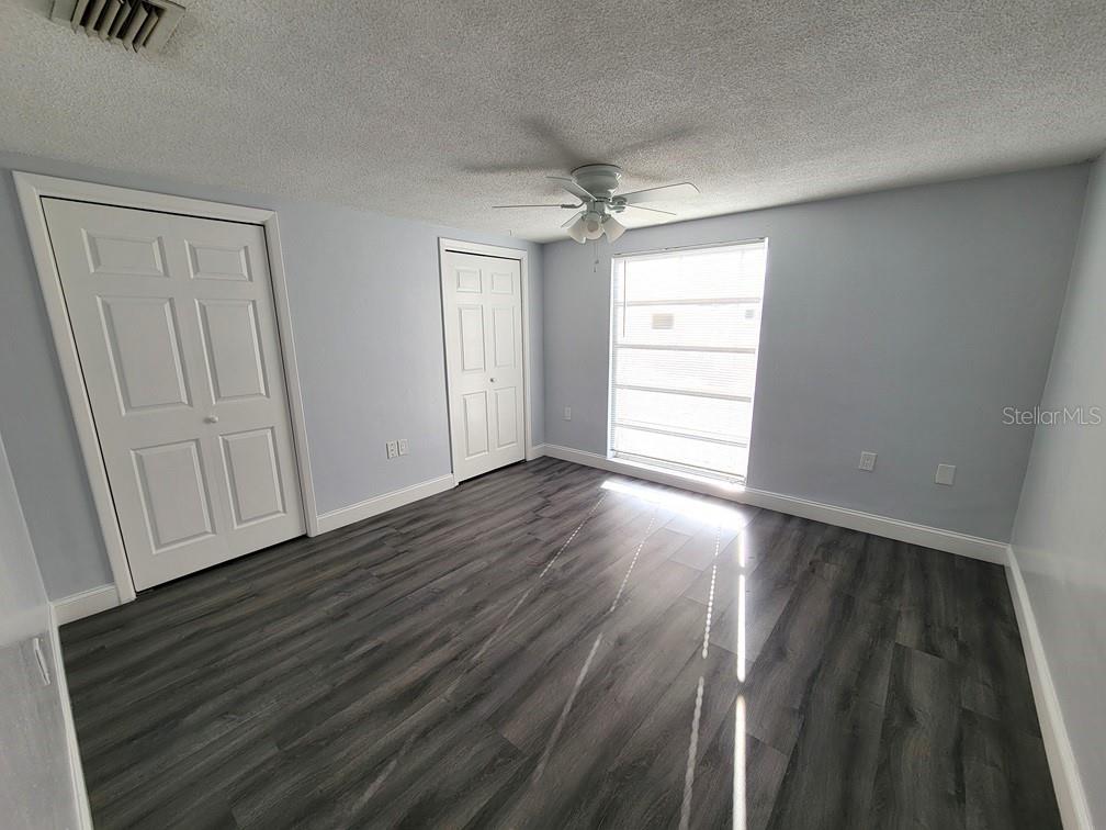 7741 Treasure Pointe Drive Port Richey, FL 34668 - Photo 18 of 20 wooden floor in an empty room with a window