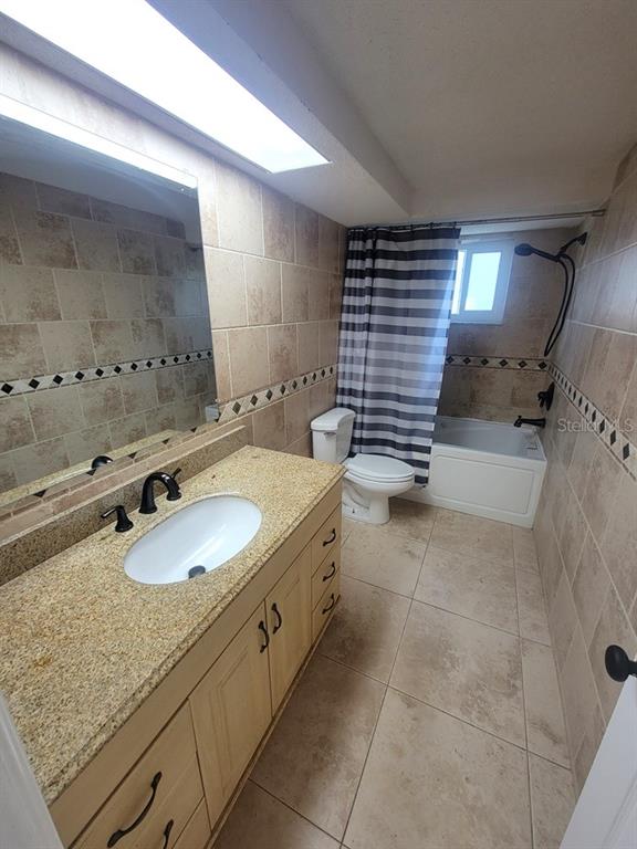 7741 Treasure Pointe Drive Port Richey, FL 34668 - Photo 20 of 20 a bathroom with a granite countertop sink and a mirror