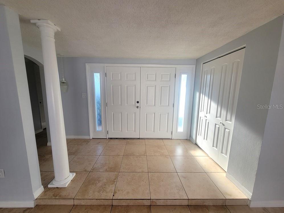 7741 Treasure Pointe Drive Port Richey, FL 34668 - Photo 3 of 20 a view of a hallway to rooms