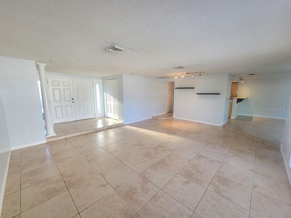 7741 Treasure Pointe Drive Port Richey, FL 34668 - Photo 4 of 20 a view of a livingroom and a kitchen