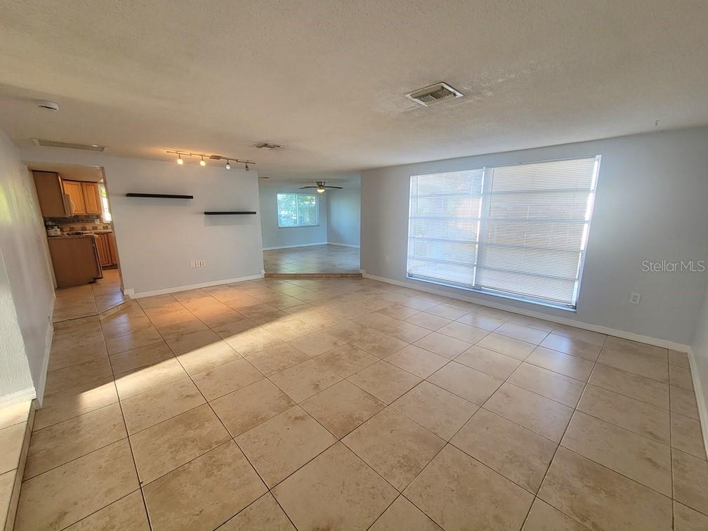 7741 Treasure Pointe Drive Port Richey, FL 34668 - Photo 6 of 20 an empty room with a empty space and windows