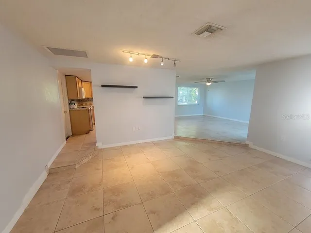 a view of a hallway with a kitchen