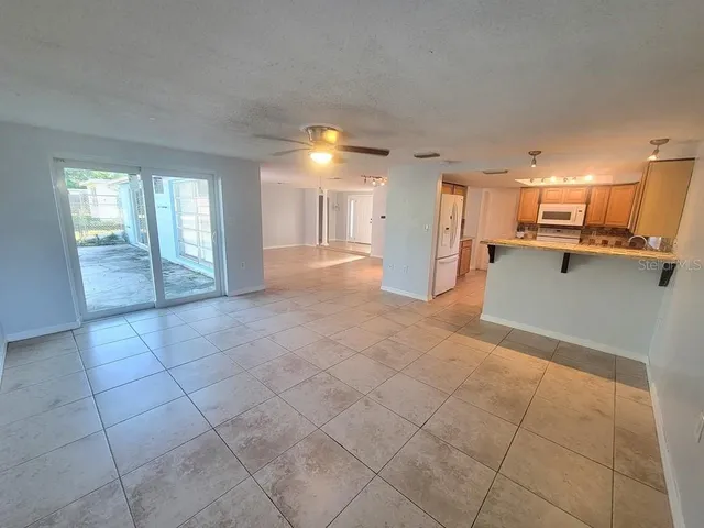 a view of a kitchen with a sink and cabinets