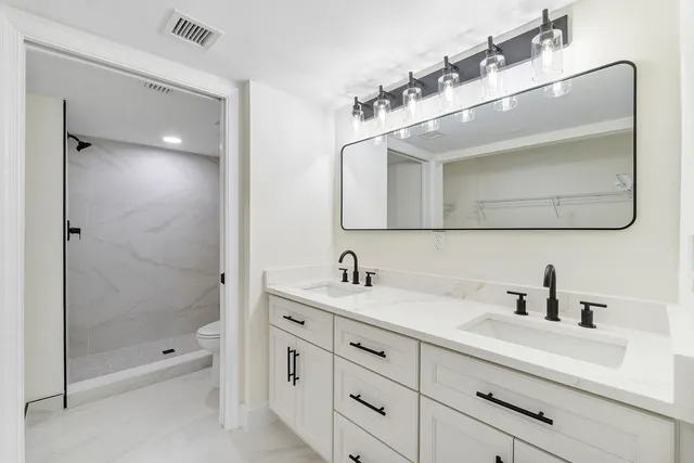a bathroom with a sink a shower and a mirror