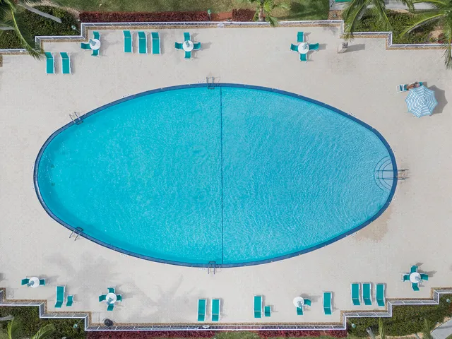 an aerial view of a house with swimming pool patio and outdoor seating