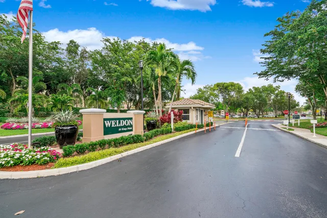 a front view of a house with a yard and potted plants