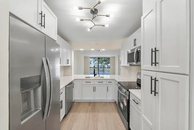 a kitchen with cabinets and stainless steel appliances