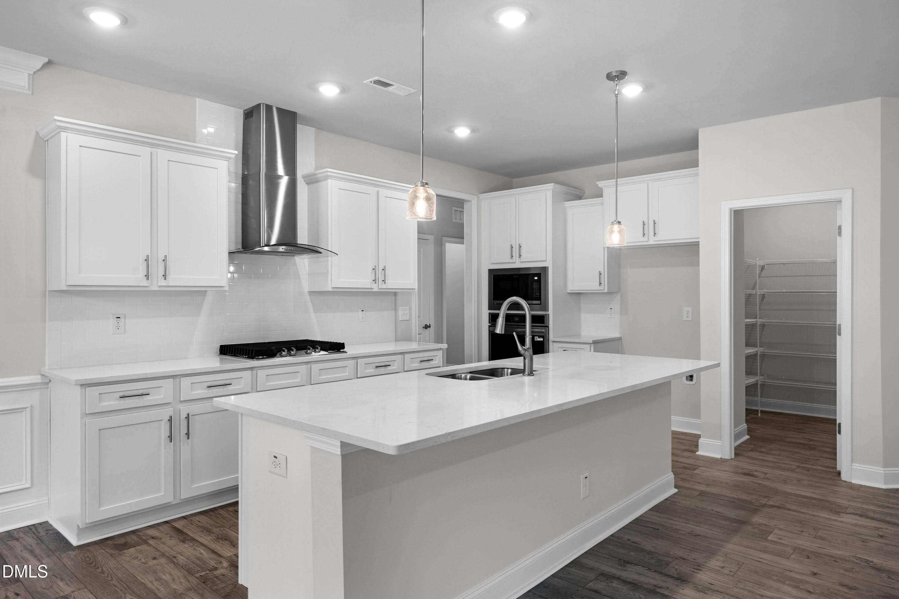88 Galway Road Lillington, NC 27546 - Photo 11 of 36 a kitchen with kitchen island a white cabinets and refrigerator