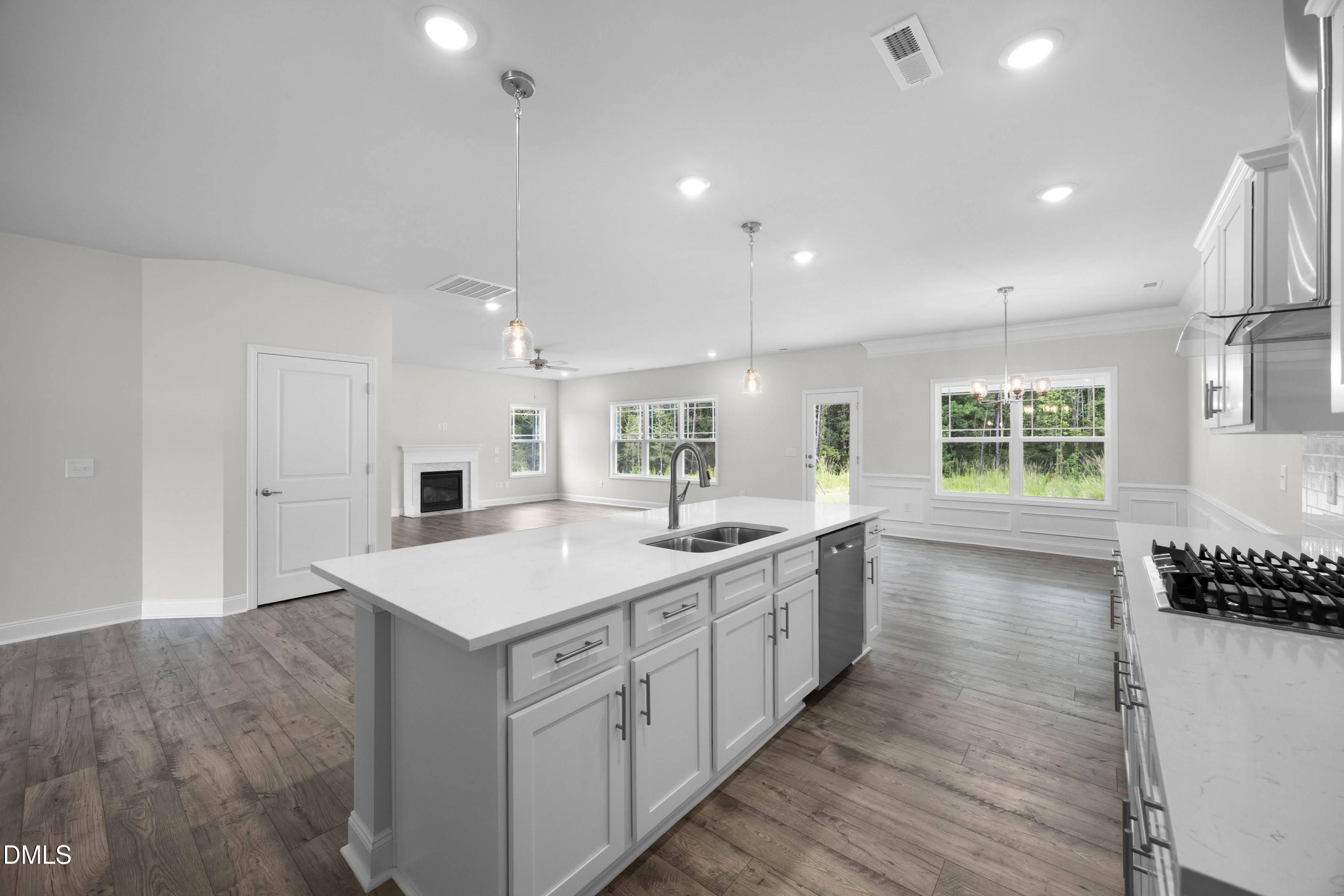 88 Galway Road Lillington, NC 27546 - Photo 13 of 36 a large kitchen with kitchen island a sink dishwasher a stove and a refrigerator with wooden floor