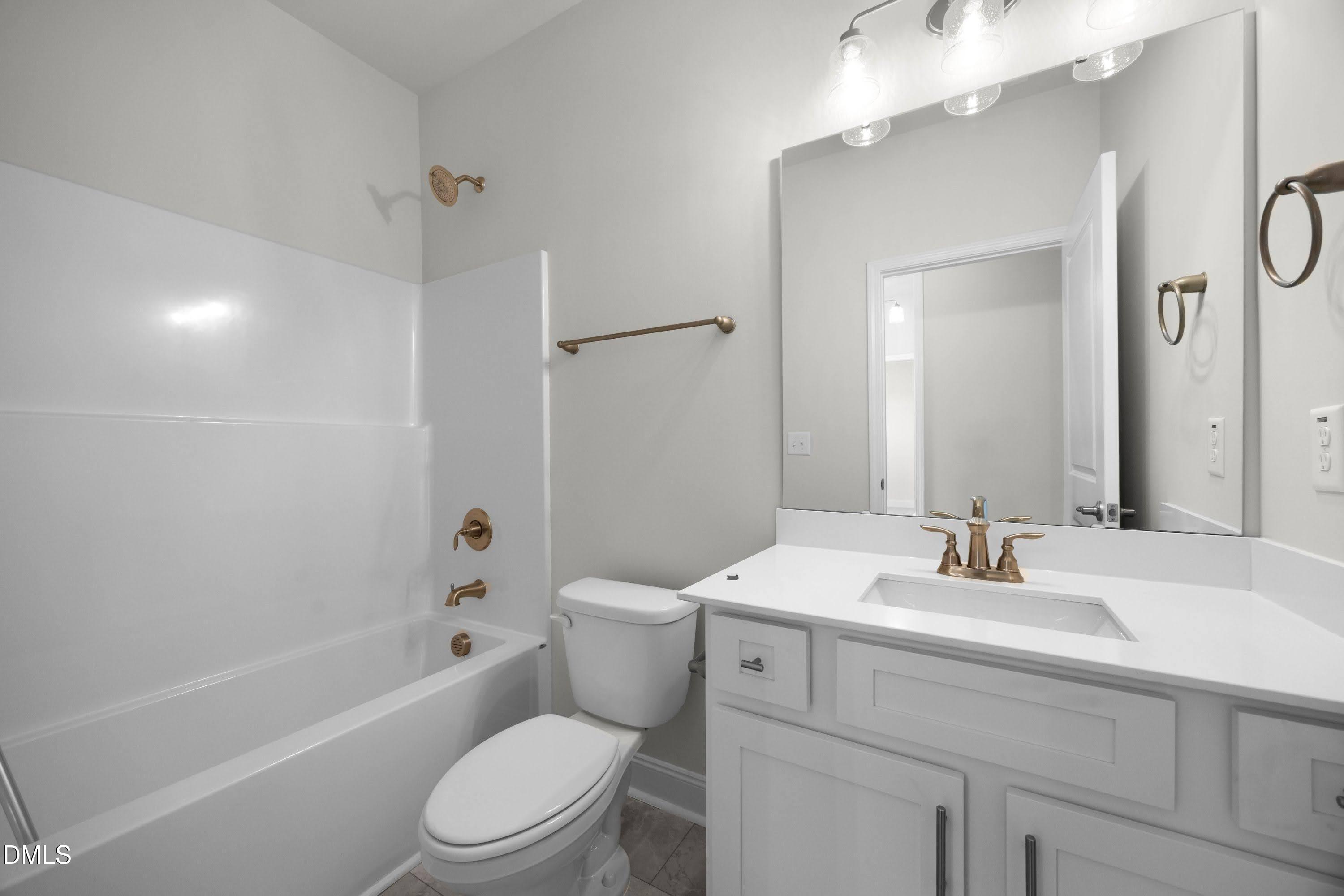 88 Galway Road Lillington, NC 27546 - Photo 29 of 36 a bathroom with a sink toilet vanity tub and shower