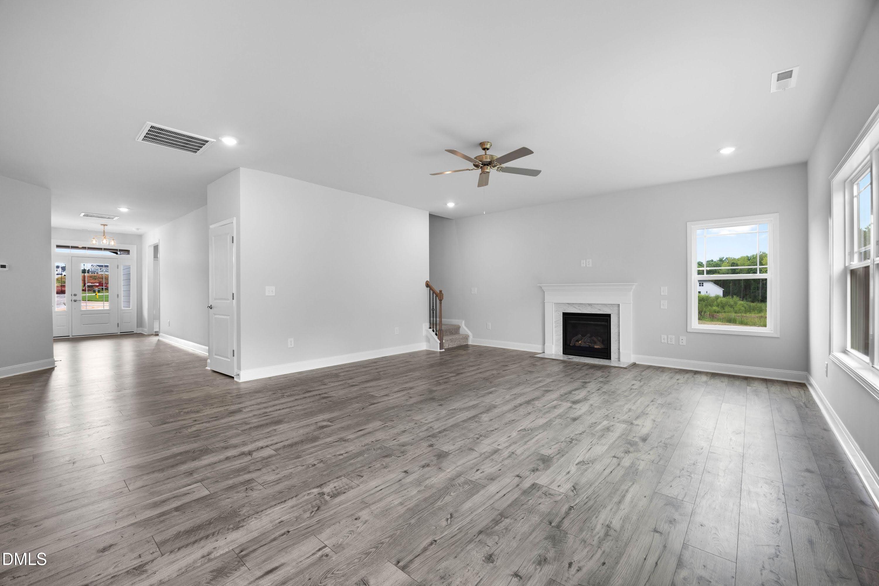 88 Galway Road Lillington, NC 27546 - Photo 3 of 36 a view of an empty room with wooden floor and a fireplace