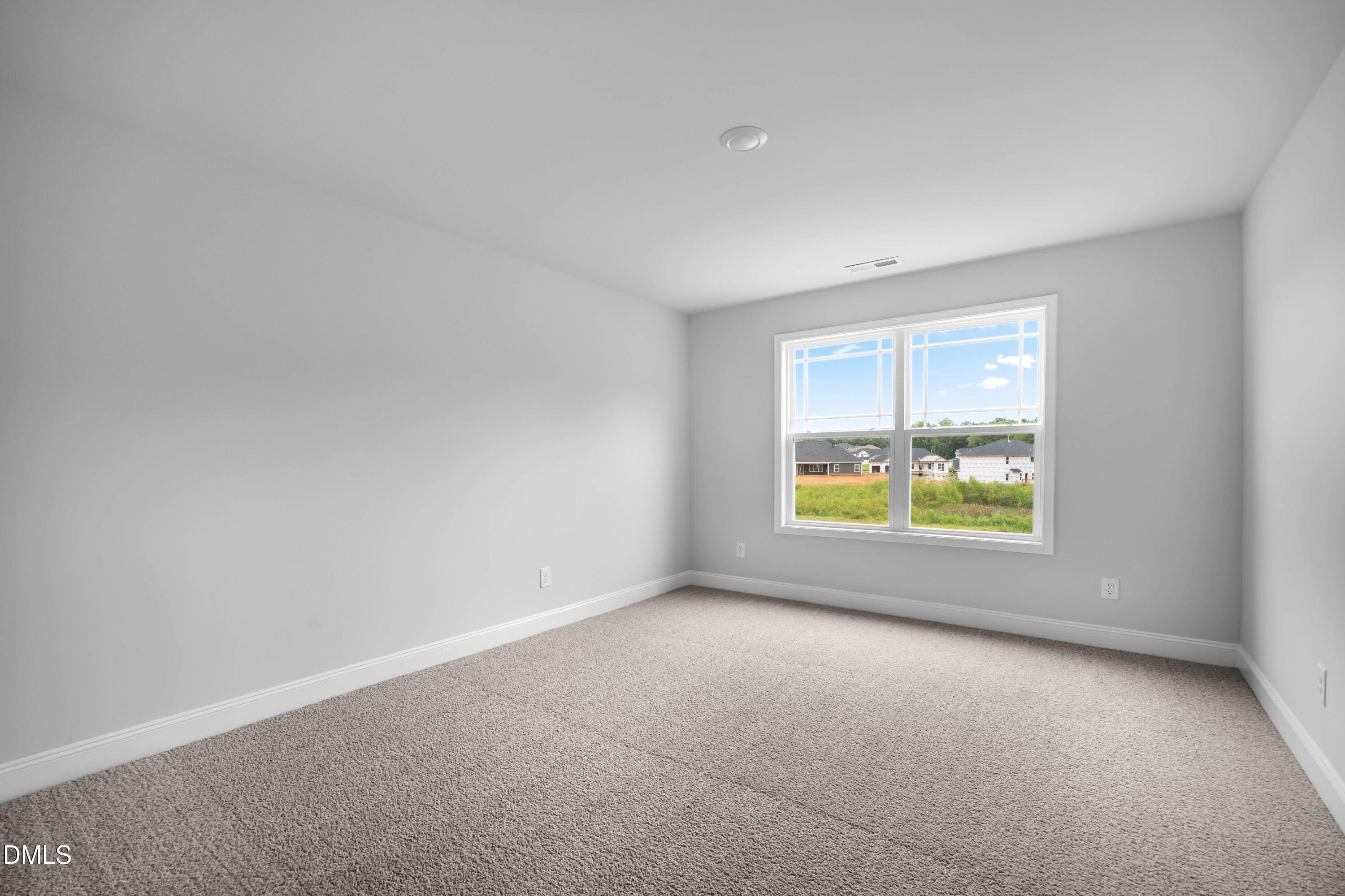 88 Galway Road Lillington, NC 27546 - Photo 33 of 36 an empty room with a window and yard