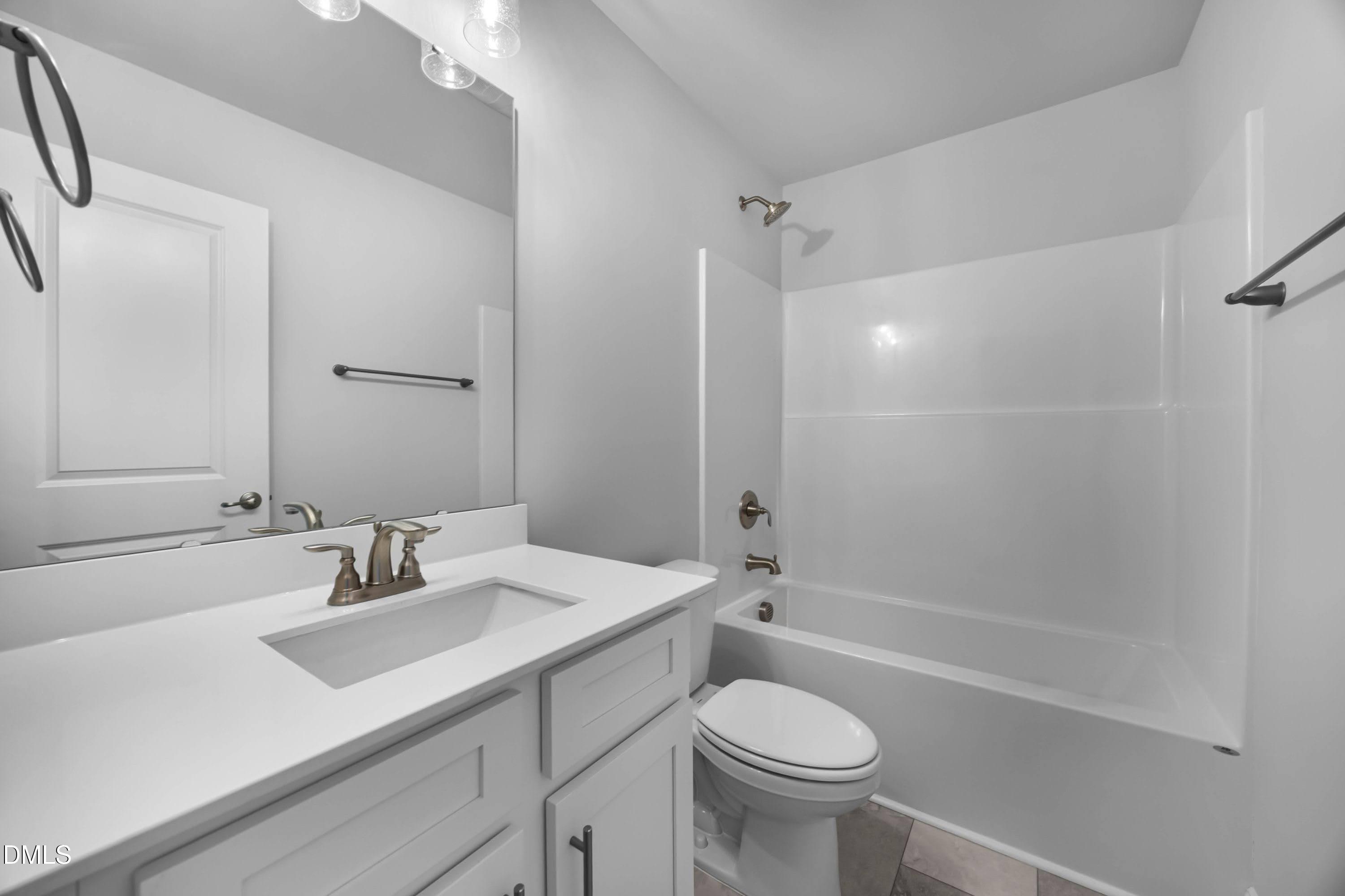 88 Galway Road Lillington, NC 27546 - Photo 35 of 36 a bathroom with a sink toilet a mirror and shower
