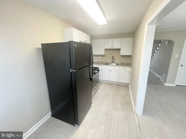 a kitchen with a refrigerator and a sink