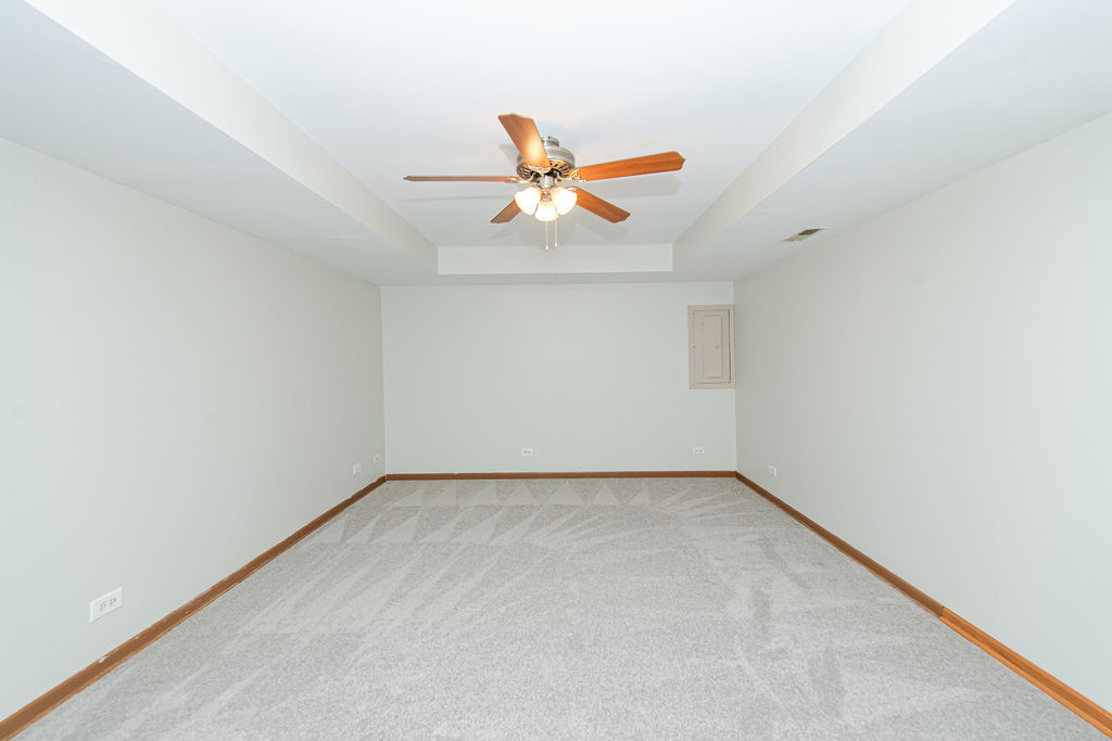 25696 Raska Lane, Unit A Lake Villa, IL 60046 - Photo 26 of 31 an empty room with a window and a ceiling fan