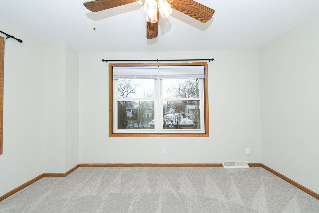 25696 Raska Lane, Unit A Lake Villa, IL 60046 - Photo 6 of 31 an empty room with windows and fan