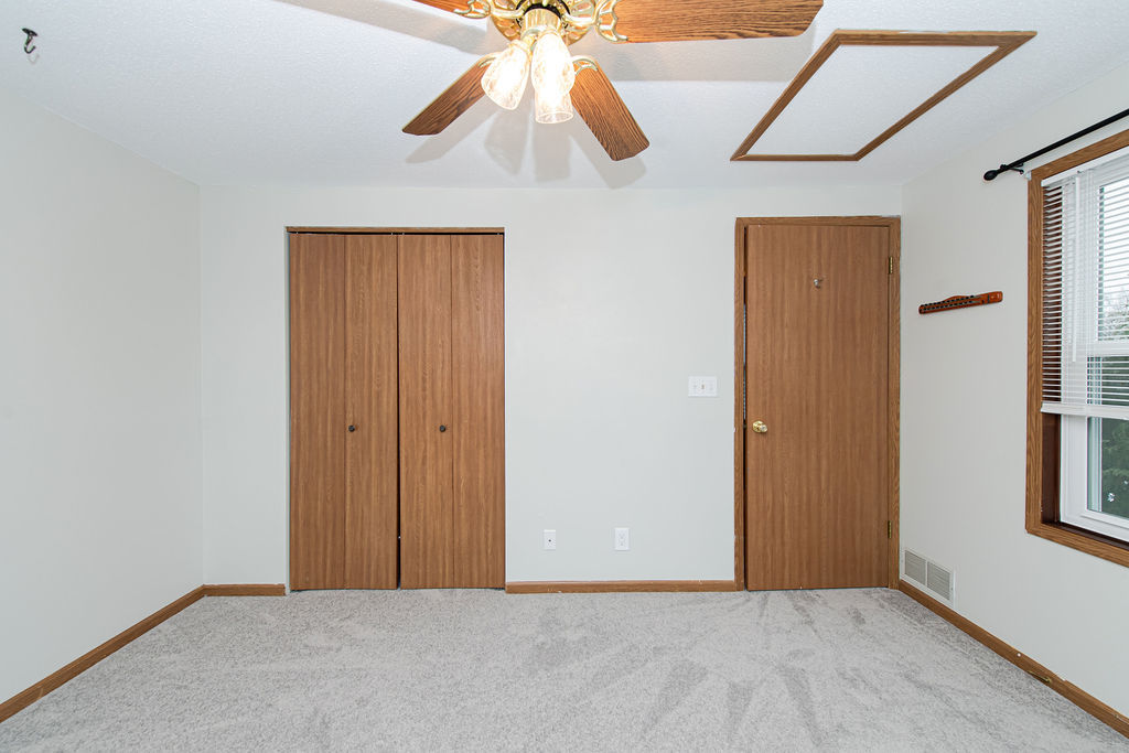 25696 Raska Lane, Unit A Lake Villa, IL 60046 - Photo 8 of 31 a view of an empty room with window and chandelier fan