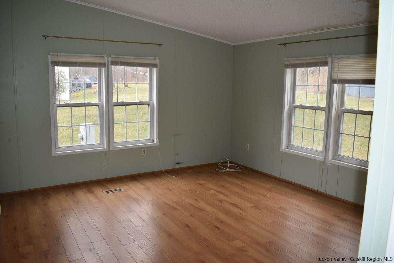 34 Depew Park Wallkill, NY 12589 - Photo 12 of 14 a view of an empty room with wooden floor and a window