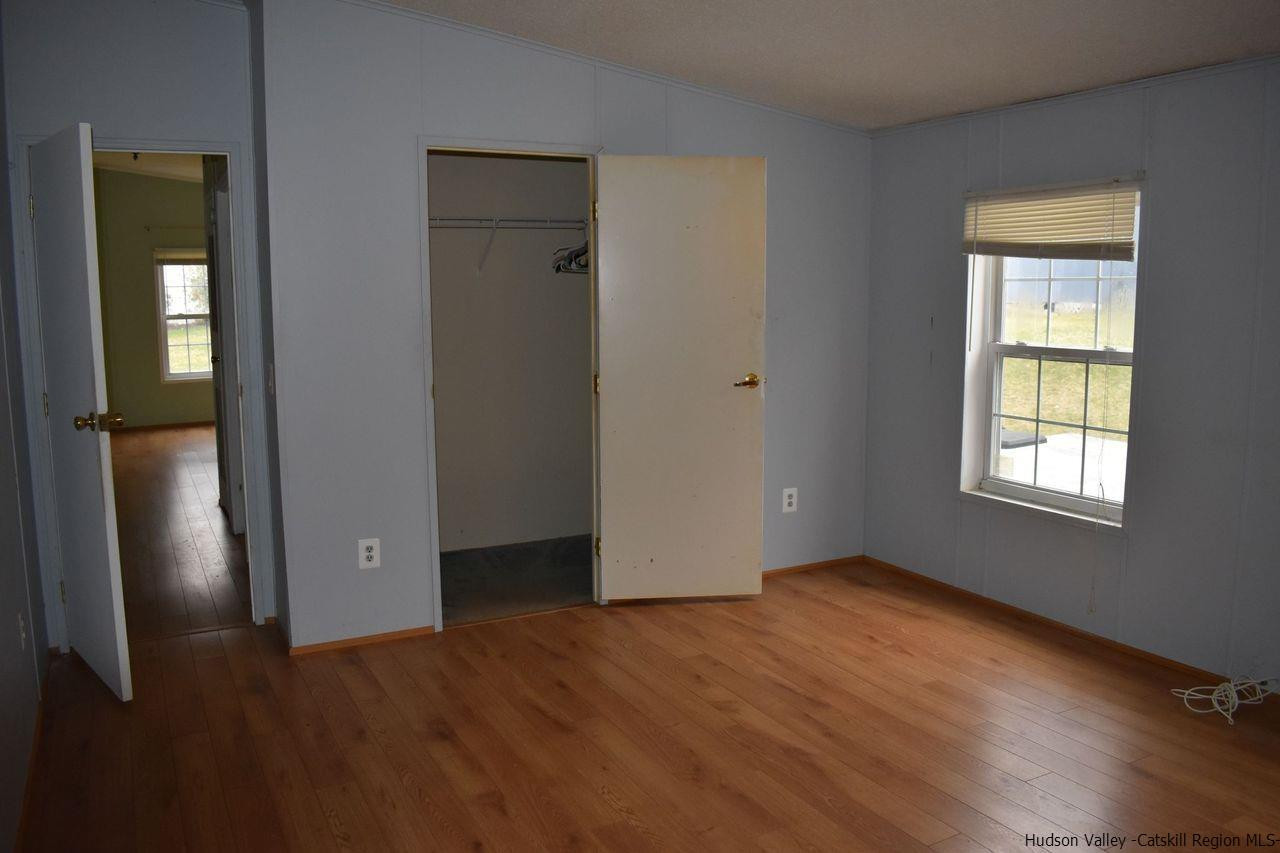34 Depew Park Wallkill, NY 12589 - Photo 4 of 14 an empty room with wooden floor and windows