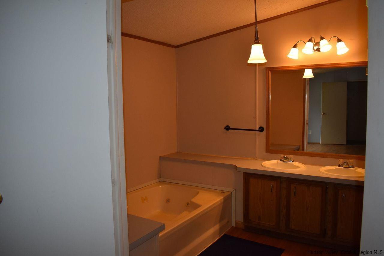 34 Depew Park Wallkill, NY 12589 - Photo 5 of 14 a bathroom with a tub and a sink