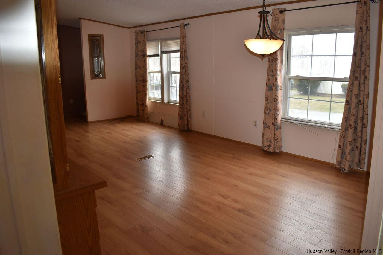 34 Depew Park Wallkill, NY 12589 - Photo 9 of 14 a view of an empty room with a window and wooden floor