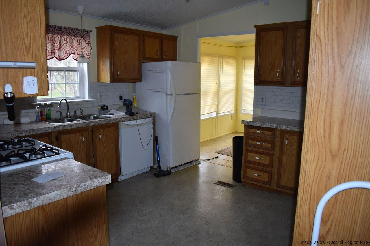 34 Depew Park Wallkill, NY 12589 - Photo 10 of 14 a kitchen with granite countertop a refrigerator stove and sink
